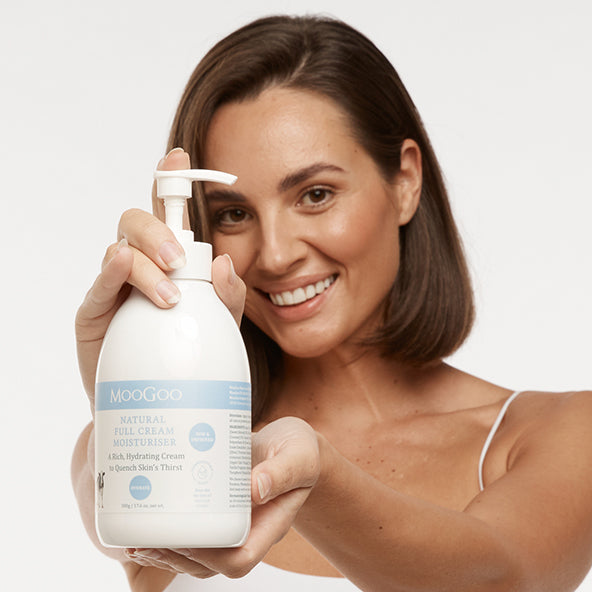 Close-up of MooGoo Full Cream Moisturiser tube in hand, nourishing face and body cream for all skin types and ages