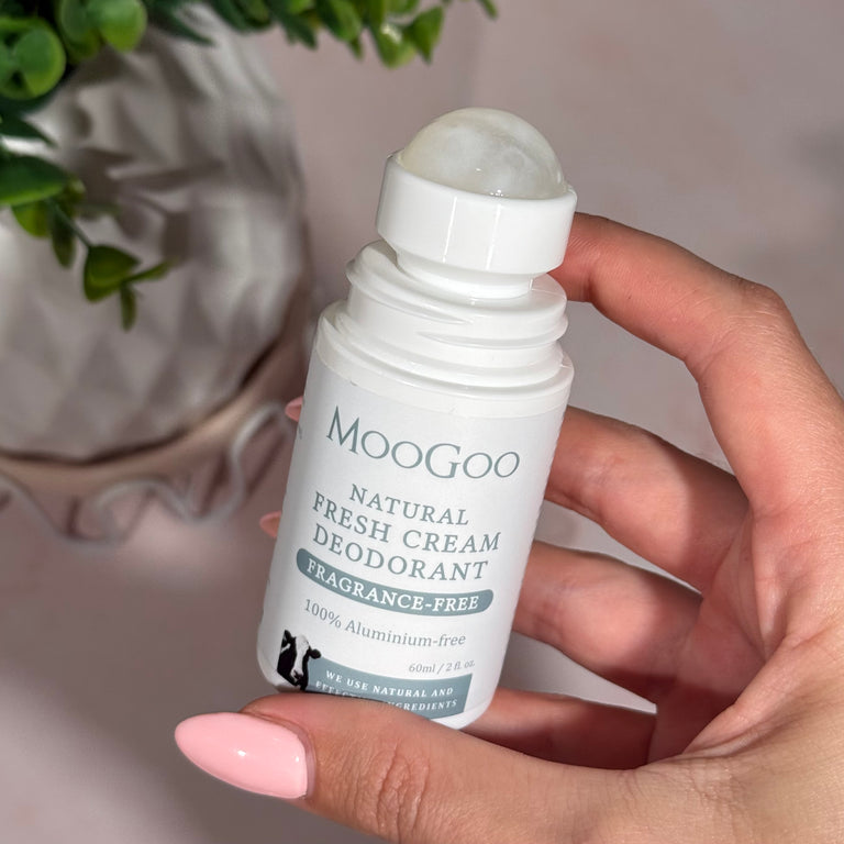 MooGoo Sensitive Fresh Cream Deodorant in hand on indoor background, natural unscented roll-on for long lasting odour protection