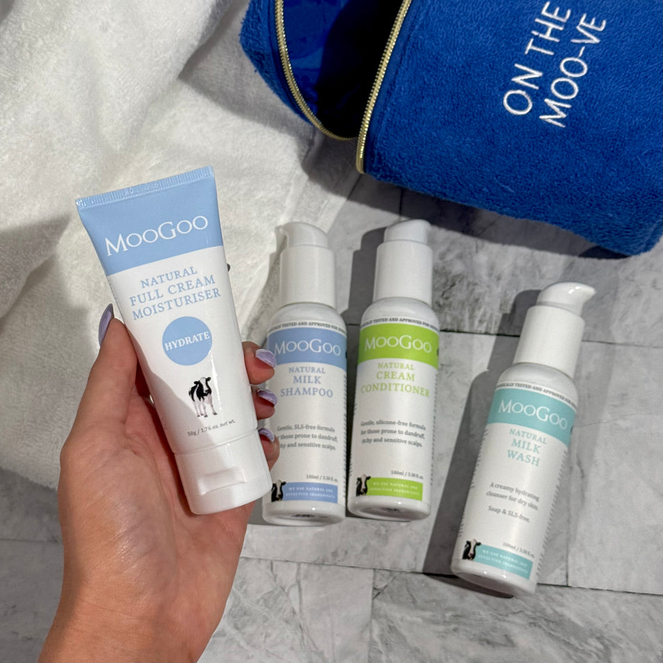 MooGoo Travel Pack on tiles with a plant in the background, including travel-sized Milk Shampoo, Cream Conditioner, Milk Wash and Full Cream Moisturiser - ideal for sensitive skin, hydration and scalp health